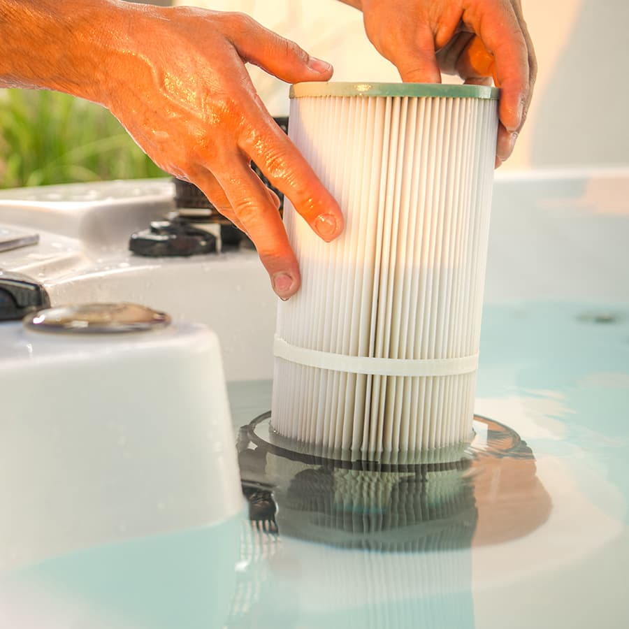 Rexine Spa Care technician installing a clean filter in a spa